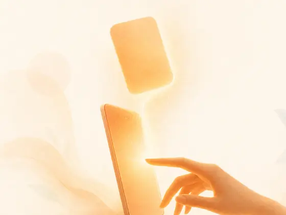 A fingertip rests on a glowing phone as a small card of warm light lifts off the screen, like a typed note taking shape.